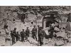 Żołnierze 2 Korpusu Polskiego w zburzonych wnętrzach opactwa. Na lewo widoczny jest fragment posągu. Podpis na odwrocie: W ruinach klasztoru na Monte Cassino.